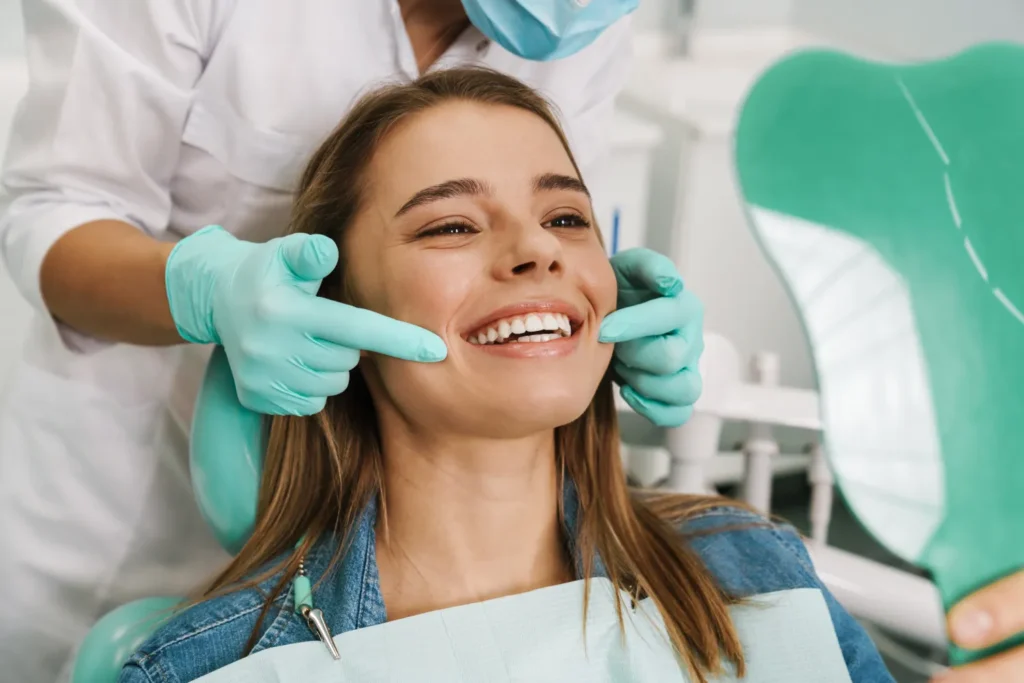 Woman smiling while receiving treatment by a doctor